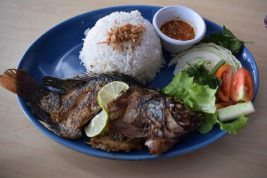 Delicious fried tilapia with white rice served on the table