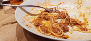 leftovers from spaghetti on a white plate