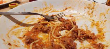 leftovers from spaghetti on a white plate