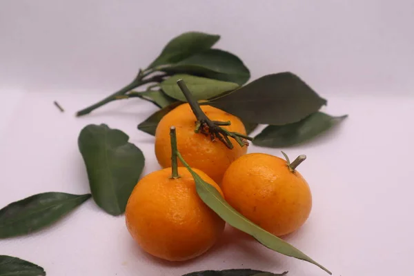 Fresh Sicilian orange,  mandarin with green leaves on white background.