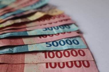 Indonesian rupiah banknotes in denominations isolated on white background