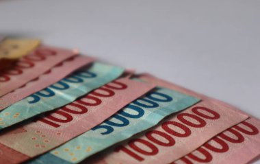 Indonesian rupiah banknotes in denominations isolated on white background