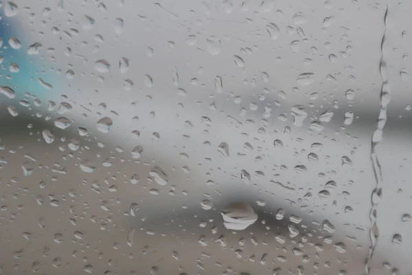 stock image raindrops on plane window, blurry photo of plane