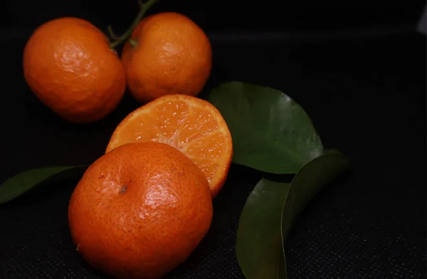 stock image A vibrant citrus fruit, the bitter orange stands out against a stark black background in this studio shot. Perfect for healthy eating and wellbeing!