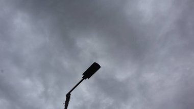 Electric light on blue sky in sunny weather. Lamp for home garden lighting.