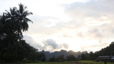 Arkasında Endonezya pirinç tarlaları olan dağlarda gün batımı, çok güzel bir manzara..