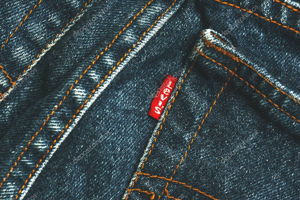 Closeup of Levis red tag on back side pocket. Classic blue Levis jeans. Levi Strauss is an american clothing company