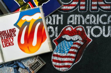 Rolling Stones logosu olan bir tişörtün üzerinde İngiliz rock grubu The Rolling Stones 'un CD' leri. İllüstrasyon Editörü
