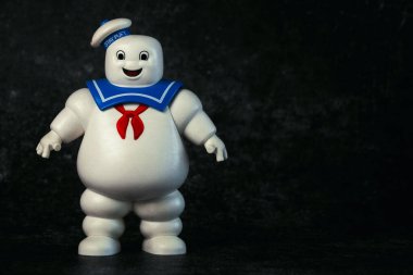 Playmobil Stay Puft Marshmallow Man character of the movie Ghostbusters over dark background. Illustrative editorial clipart