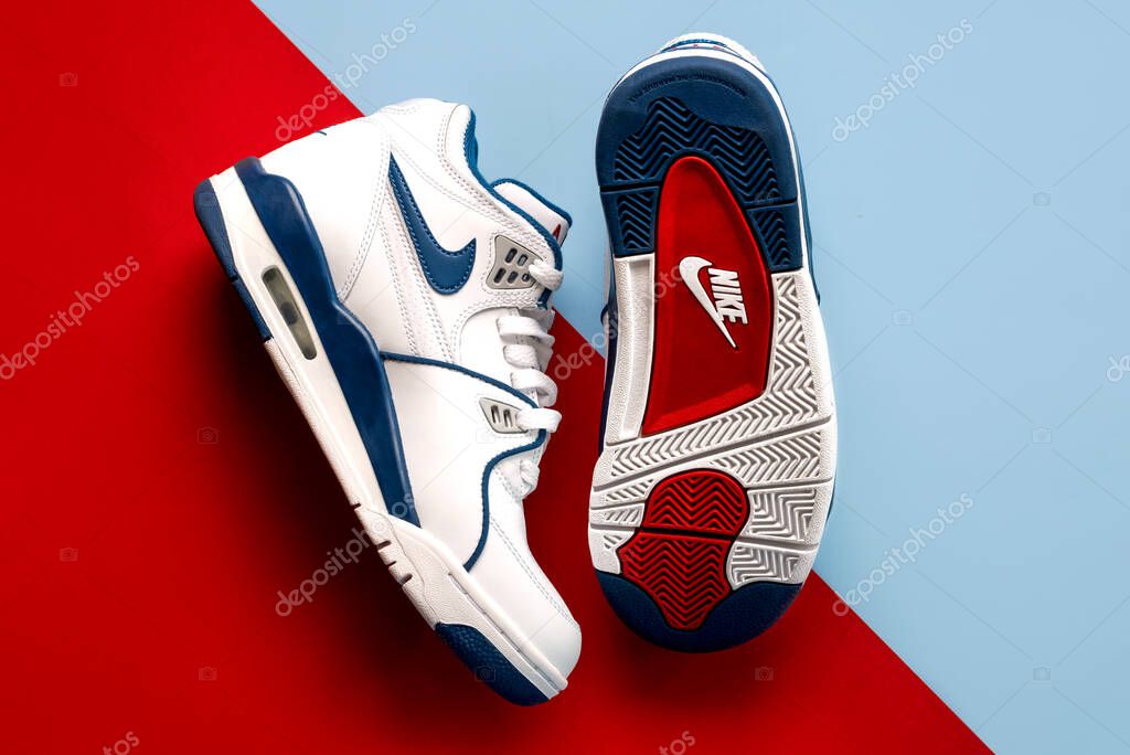 Top view of Nike sport shoes Air Flight 89 over blue and red background. Illustrative editorial