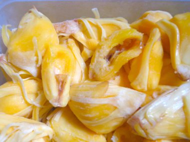 Jackfruit that has been frozen and put into a white plastic container.