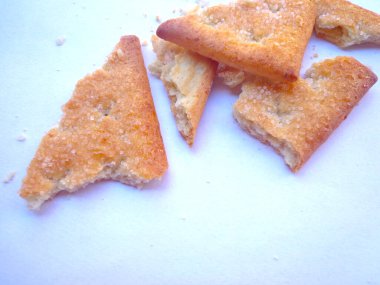 Beyaz arka planda izole edilmiş şekerli bisküvilerin parçaları..