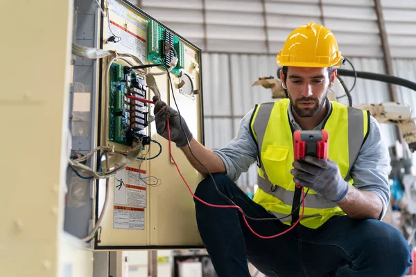 stock image Robotics engineer working on maintenance of modern robotic arm in factory warehouse