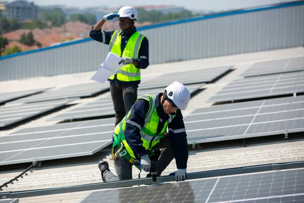 Technology solar cell, Engineer service check installation solar cell on the roof of factory. technicians checking the maintenance of the solar panels, engineering team working on checking and maintenance in solar power plant