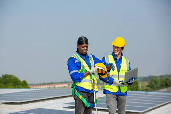 engineers working on the farm, young african american engineer and technician standing on solar panel