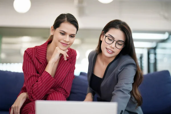 stock image two cheerful businesswomen working in office