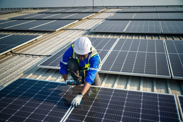 engineer installing solar panels on roof. Male engineer working