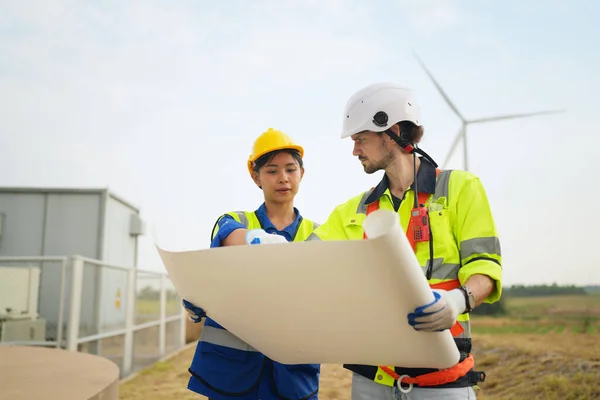 Stock image Wind turbine service engineer maintenance and plan for inspection at construction site, renewable electricity generator