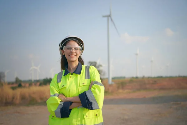 Wind turbine service engineer maintenance and plan for inspection at construction site, renewable electricity generator.
