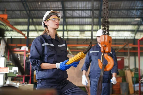 Female empowerment, working female industry technical worker or engineer woman working in an industrial manufacturing factory.