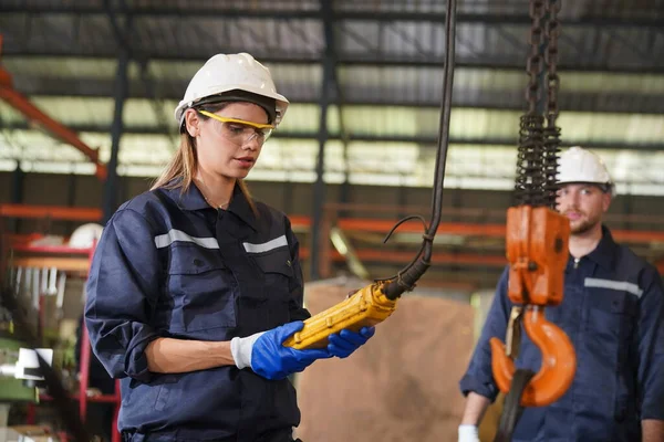 Female empowerment, working female industry technical worker or engineer woman working in an industrial manufacturing factory.
