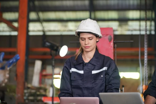 stock image Female empowerment, working female industry technical worker or engineer woman working in an industrial manufacturing factory.