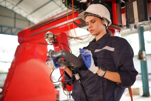 stock image Robotics engineer working on maintenance of modern robotic arm in factory warehouse