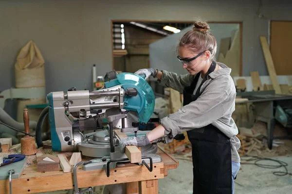 stock image Small business of young woman. Beautiful young woman worker in a furniture workroom