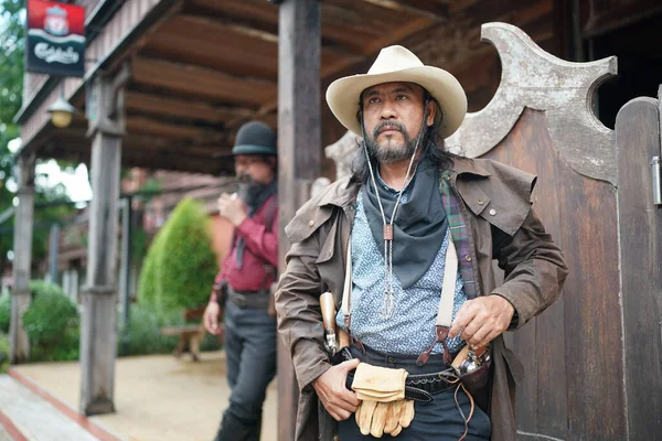 stock image Brutal cowboy with revolver on ranch