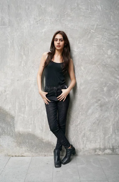 stock image Fashion Model in the studio. Beautiful Sexy Woman In Stylish Fashionable black Clothes. Young gorgeous indian female fashion model wearing Black clothes against wall background.