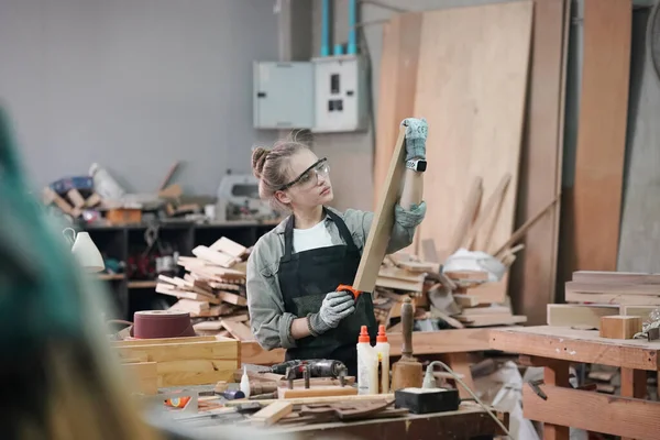 stock image Small business of a young woman. Beautiful young woman worker in a furniture workroom