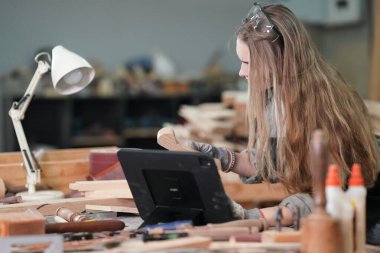 Genç bir kadının küçük işletmesi. Mobilya atölyesinde çalışan güzel genç bayan.