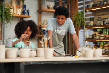 Çömlekçide yaratıcı bir çömlekçinin portresi ya da seramik ürünleri olan bir işletme sahibi.