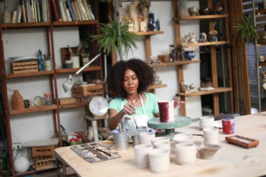 Çömlekçide yaratıcı bir çömlekçinin portresi ya da seramik ürünleri olan bir işletme sahibi.