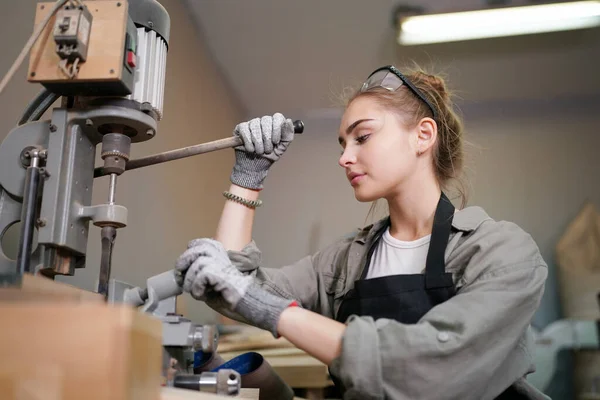 stock image Young beautiful woman doing work in the carpenter DIY workshop room. Small Business owner, young woman who working at furniture factory.