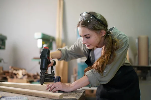 stock image Small business of young woman. Beautiful young woman worker in a furniture workroom