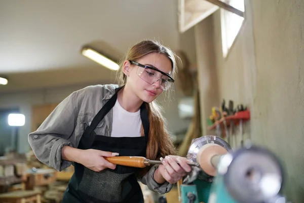 stock image Small business of a young woman. Beautiful young woman worker in a furniture workroom