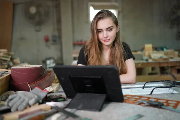 stock image Small business of a young woman. Beautiful young woman worker in a furniture workroom