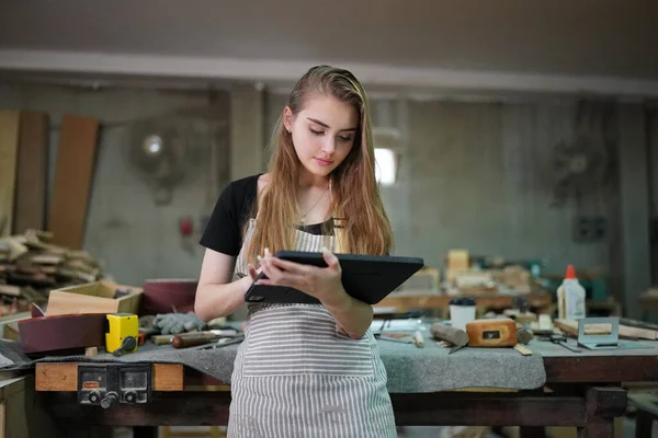 stock image Small business of a young woman. Beautiful young woman worker in a furniture workroom