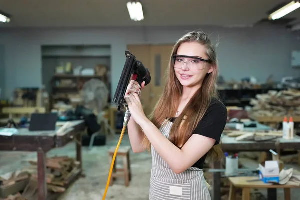 stock image Small business of a young woman. Beautiful young woman worker in a furniture workroom