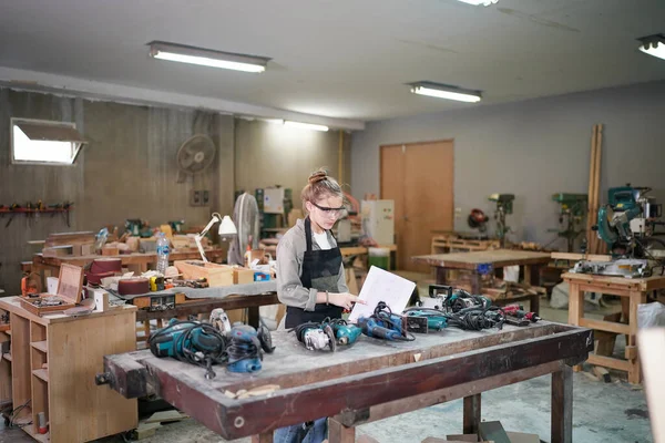 stock image Small business of a young woman. Beautiful young woman worker in a furniture workroom