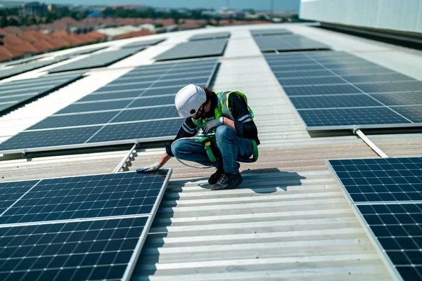 Technology solar cell, Engineer  checking installation solar cell on the roof of factory. technician checks the maintenance of the solar panels