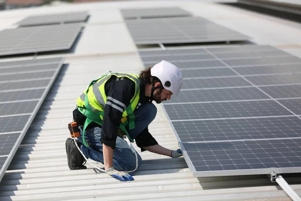 Technology solar cell, Engineer service checks installation solar cell on the roof of factory. technician checks the maintenance of the solar panels