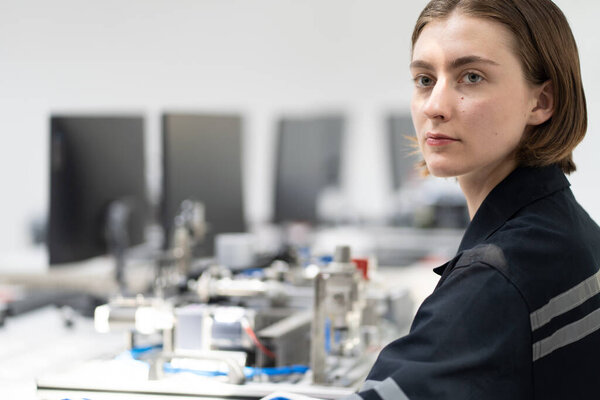 Engineer checking and controling welding robotics automatic arms machine in intelligent factory automotive industrial with monitoring system software. Digital manufacturing operation. Industry 4.0