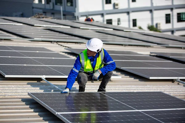 Technology solar cell, Engineer service check installation solar cell on the roof of factory. technician checks the maintenance of the solar panels