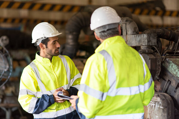 Worker at machine in factory, Metal industry worker at factory.
