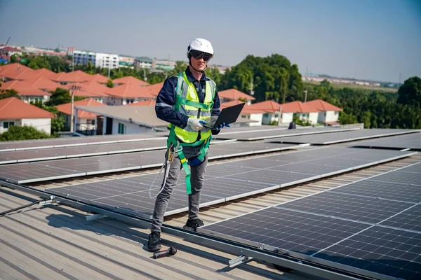 stock image Technology solar cell, Engineer  checking installation solar cell on the roof of factory. technician checks the maintenance of the solar panels