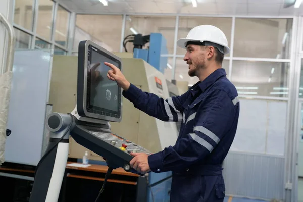 male technician using computer in factory