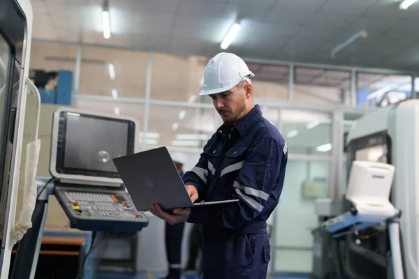 worker using laptop in factory
