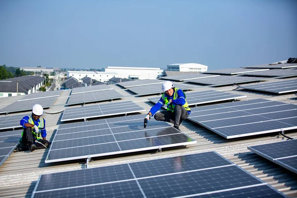 Technology solar cell, Engineer service check installation solar cell on the roof of factory. technicians checking the maintenance of the solar panels, engineering team working on checking and maintenance in solar power plant